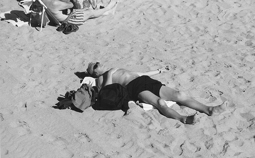  Young man laid on the sand